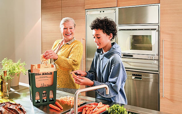 Senior lady and kid cooking together.